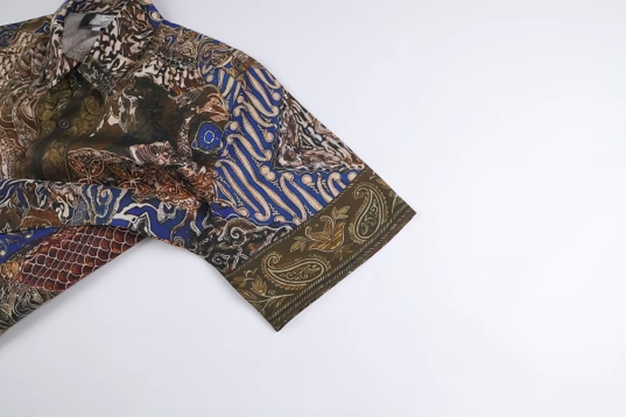 Crest of Jormungandr Resort Shirt | Hand-Drawn World Serpent Mythology Batik Parang Diagonal Waves Megamendung Clouds Kawung Floral Paisley Filigree Scales & Old City Architecture in Royal Blue Indigo Olive Gold | Bold Edgy Rebel Fearless Statement Piece Wearable Art Quiet Luxury Old Money Indie Vanguard Camp Collar Resort Shirt 1 of 1 Human Made Wearable Art 2026 by Kurt Wollton DARO Studio