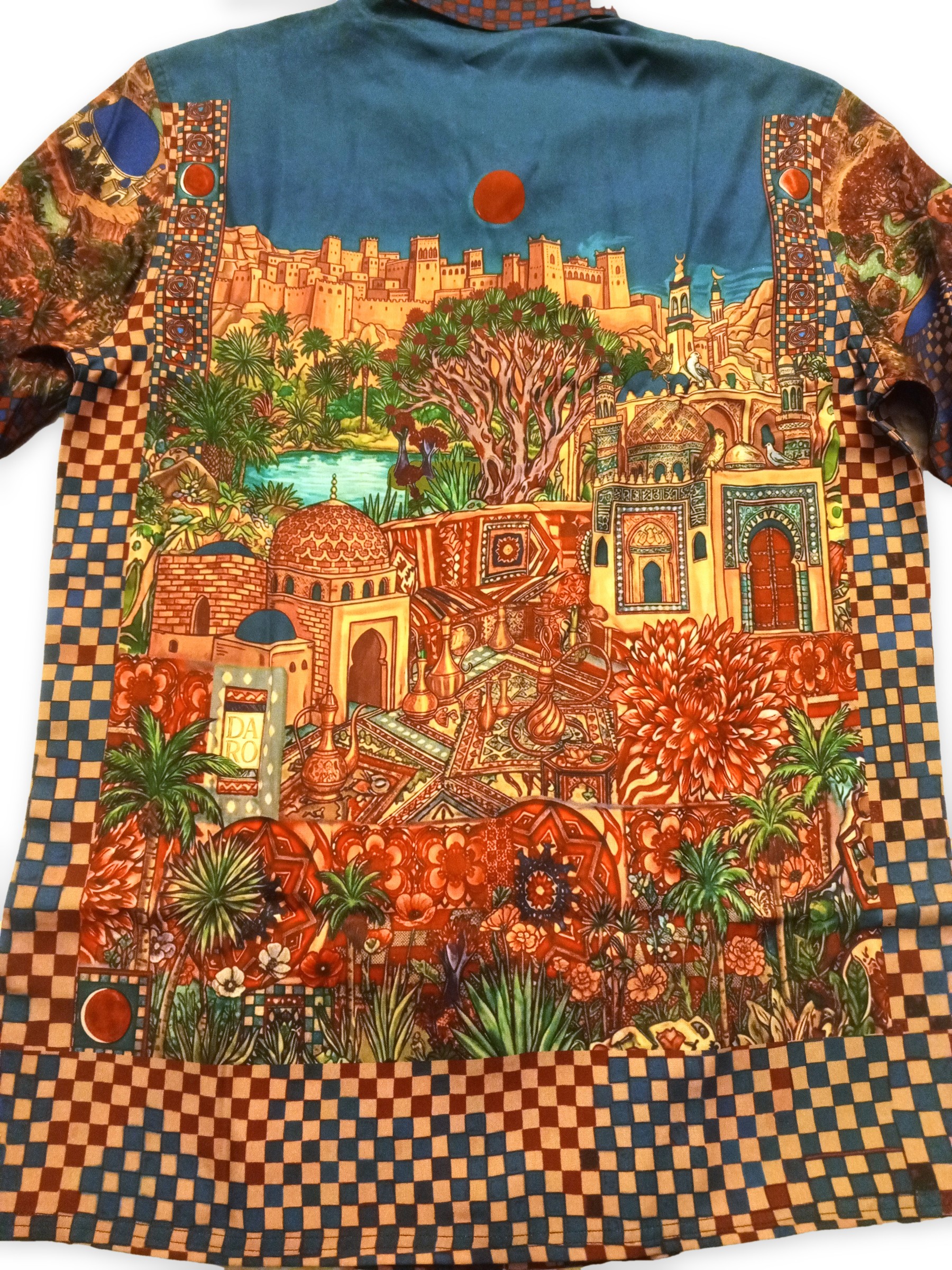 DARO Casbah Resort Shirt | Hand-Drawn Old City Kasbah Walled Citadel Fortress Architecture Islamic Domes Minarets Desert Sand Dune Padang Pasir Turquoise Oasis Waterfall Socotra Dragon Blood Tree Shisha Hookah Teapot Butterflies Succulents Checkered Border | Vintage Classic Heritage Timeless Storytelling Wearable Art Quiet Luxury Old Money Camp Collar Resort Shirt 1 of 1 Human Made Wearable Art 2026 by Kurt Wollton DARO Studio