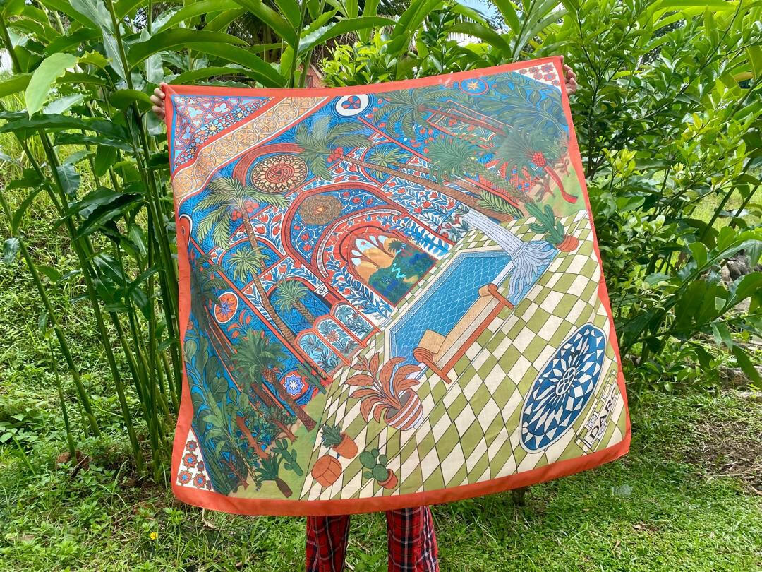Escape Moorish Square Scarf | Hand-Drawn Moorish Riad Palace Architecture Pointed Zellige Tile Arches Green & White Checkered Patio Turquoise Courtyard Swimming Pool Lounge Chair Fruiting Date Palms Potted Cacti & DARO EST 2021 Plaque in Burnt Orange Border | Escape Calm Peaceful Sanctuary Oasis Quiet Luxury Old Money Bawal Eksklusif Tudung Seni 1 of 1 Human Made Luxury Resort Scarf 2026 by Kurt Wollton DARO Studio